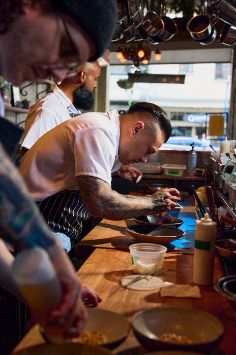 Chef Dana Francisco plates food at Le Pigeon restaurant with the team
